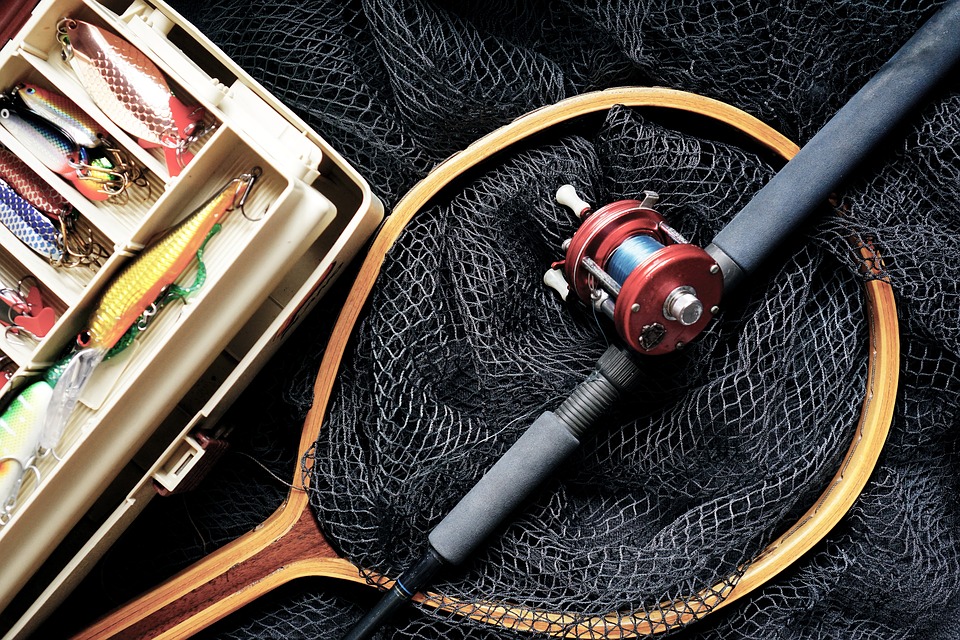 Fishing rods and reels on a black background.